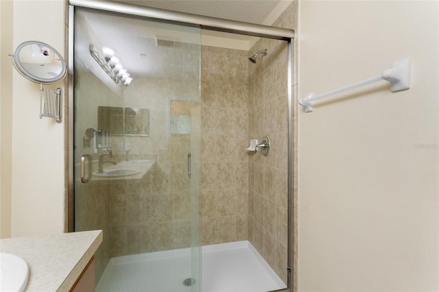 full bath featuring a stall shower and vanity