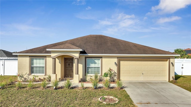 ranch-style home with a front lawn and a garage