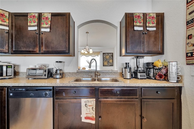 kitchen featuring sink, appliances with stainless steel finishes, dark brown cabinetry, and decorative light fixtures