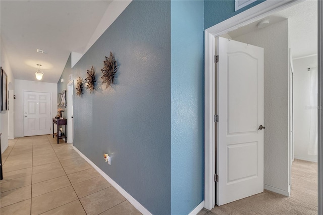 corridor with light tile patterned floors