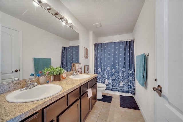 bathroom with toilet, a textured ceiling, walk in shower, tile patterned floors, and vanity