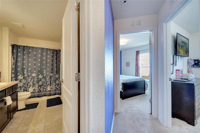 bathroom with tile patterned floors, toilet, and vanity