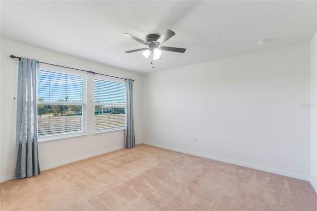 spare room with light carpet and ceiling fan