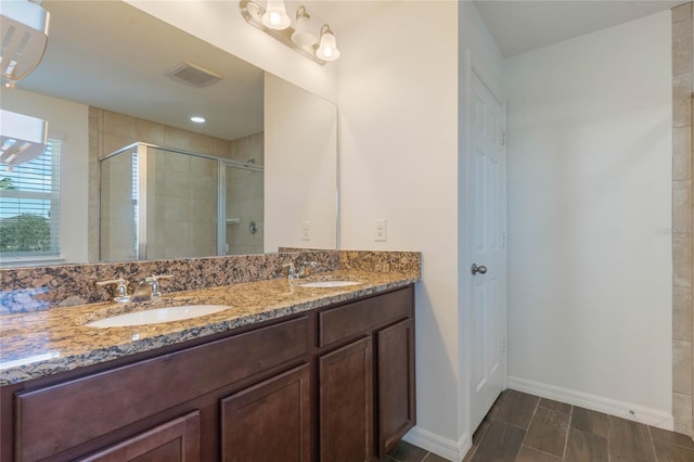 bathroom with an enclosed shower and vanity