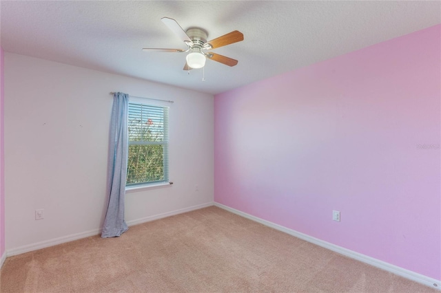 carpeted empty room featuring a textured ceiling and ceiling fan