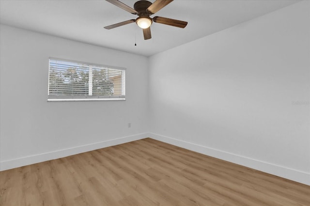 spare room with ceiling fan and light wood-type flooring