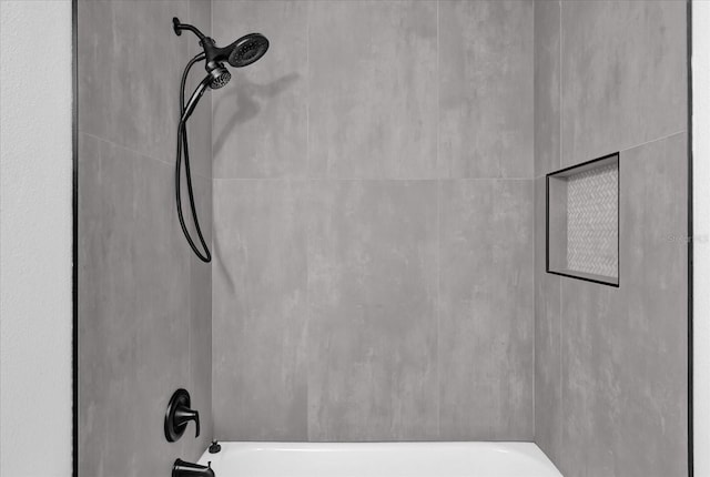 interior space with tiled shower / bath combo