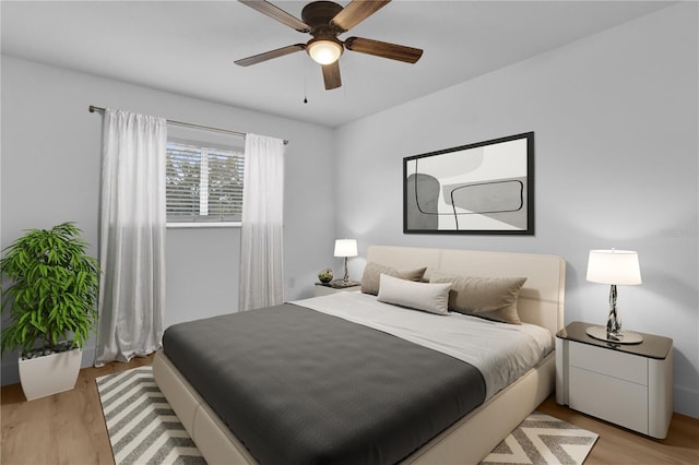 bedroom with ceiling fan and light hardwood / wood-style flooring