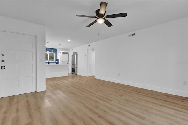 unfurnished living room with ceiling fan and light wood-type flooring