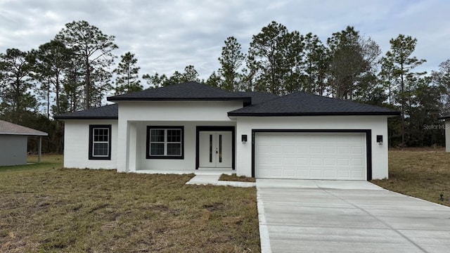 view of front of house featuring a garage and a front yard