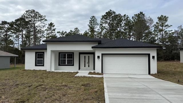 view of front of home featuring a garage and a front yard