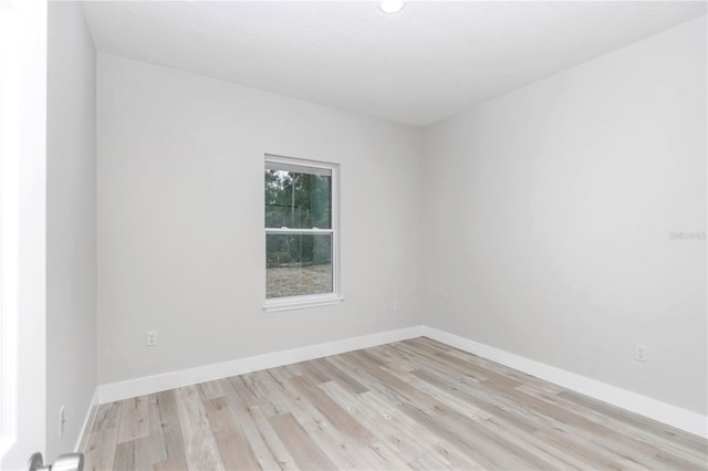 unfurnished room featuring light wood-style flooring and baseboards