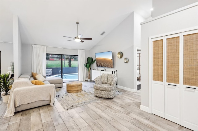 living room with ceiling fan, high vaulted ceiling, and light hardwood / wood-style flooring