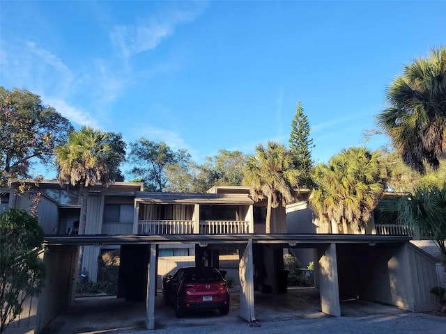 exterior space with a balcony and a carport