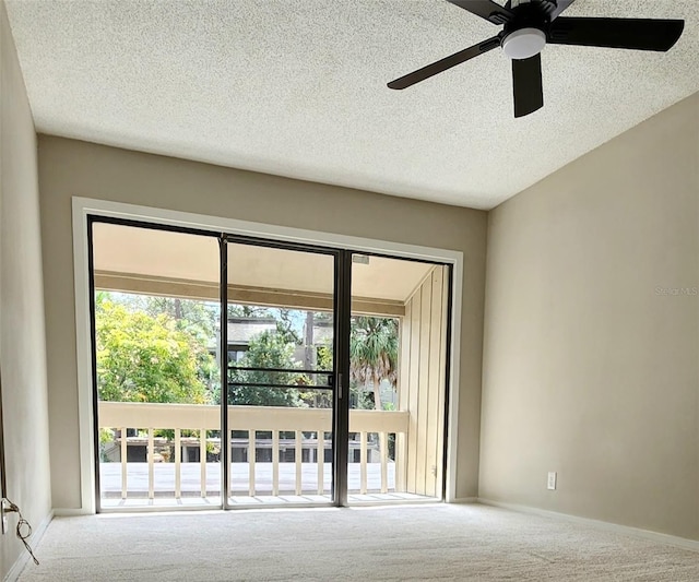 carpeted empty room with a textured ceiling