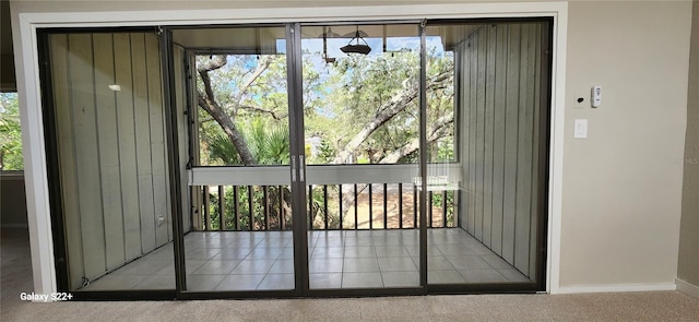 entryway featuring a healthy amount of sunlight and light carpet