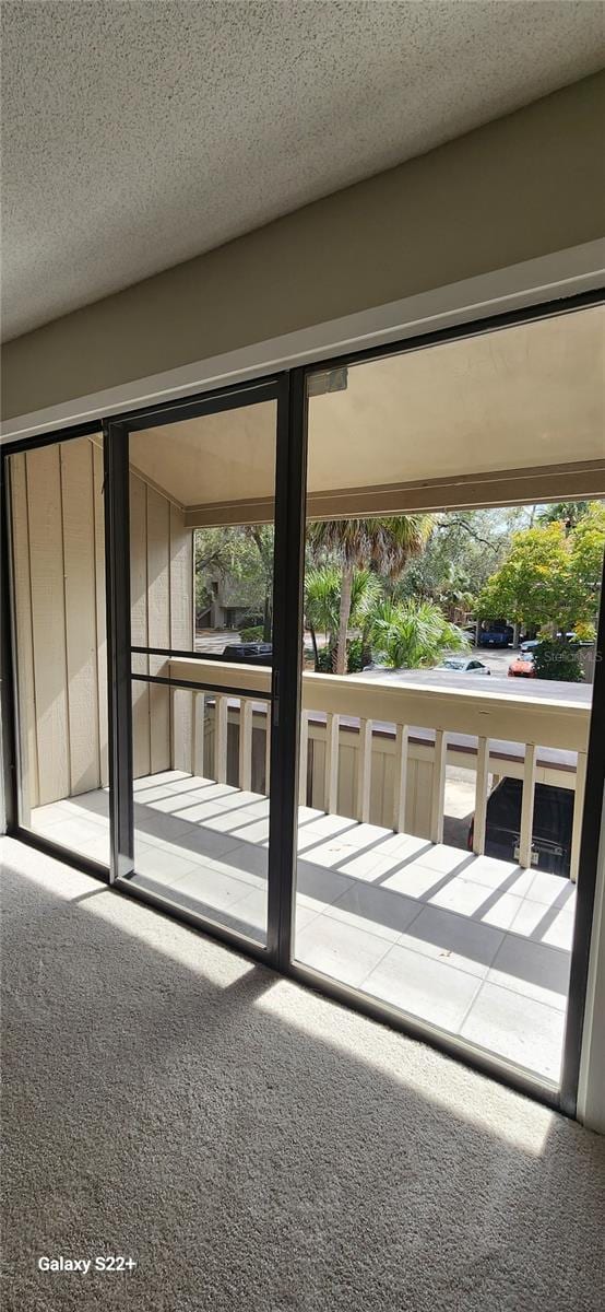 doorway to outside featuring carpet floors