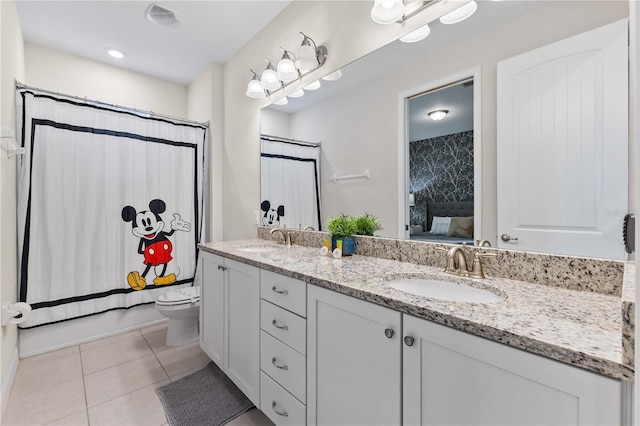 bathroom featuring tile patterned flooring, vanity, and toilet