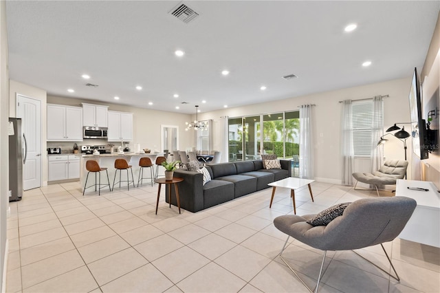 living room featuring a notable chandelier and light tile patterned floors