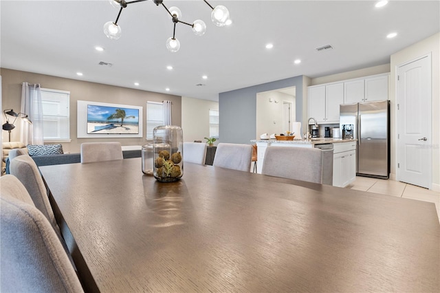 tiled dining room featuring sink