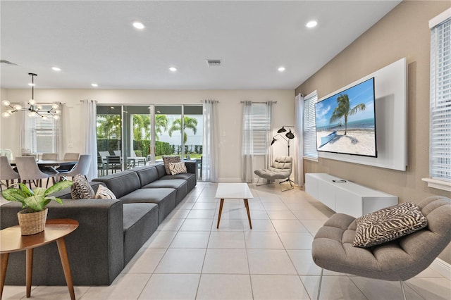 tiled living room featuring a chandelier