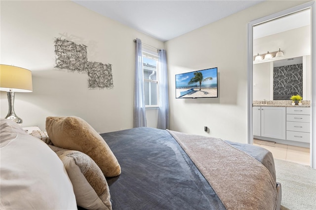 bedroom featuring connected bathroom and light tile patterned floors