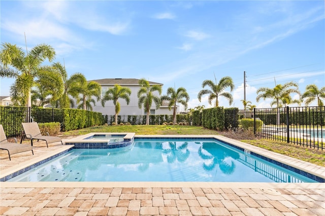 view of swimming pool with an in ground hot tub