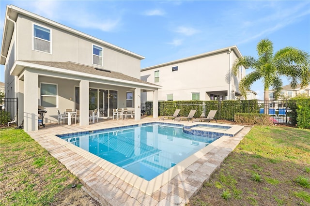 view of swimming pool featuring a yard and a patio area