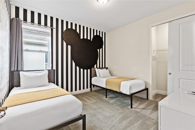 carpeted bedroom featuring a closet and a textured ceiling