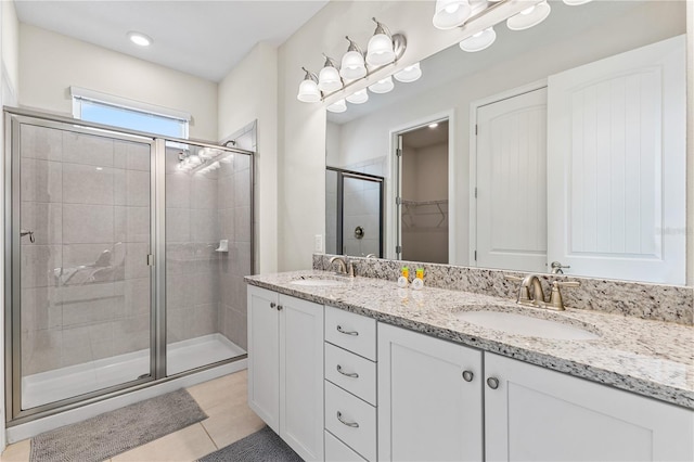 bathroom with vanity, an enclosed shower, and tile patterned floors