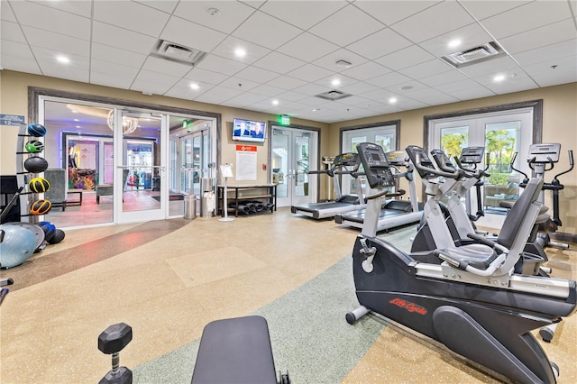 exercise room featuring french doors and a paneled ceiling