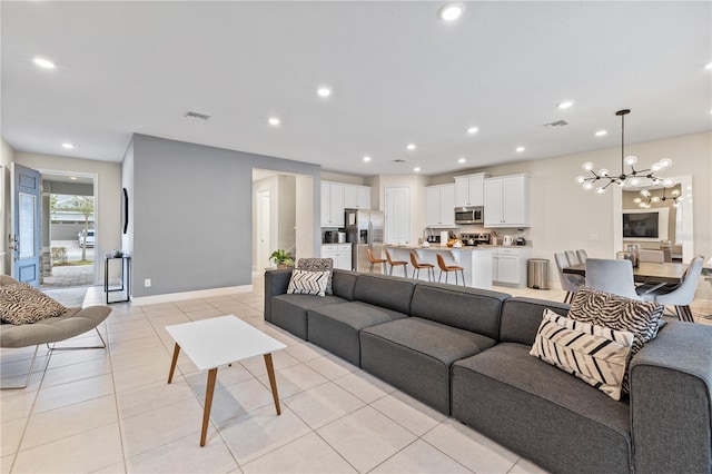 living room featuring light tile patterned floors and a chandelier