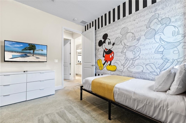 bedroom with light carpet and a textured ceiling