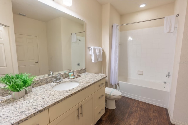 full bathroom featuring vanity, hardwood / wood-style flooring, shower / bath combination with curtain, and toilet