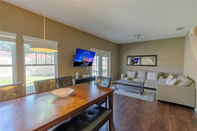 dining room featuring french doors and dark hardwood / wood-style flooring