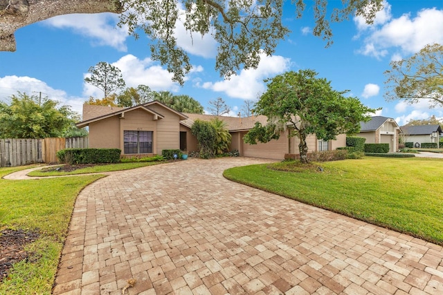 view of front of home with a garage and a front lawn