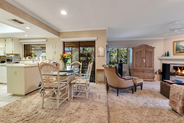 dining room with light tile patterned floors, ornamental molding, and ceiling fan