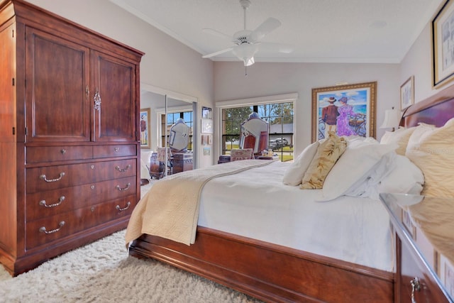 bedroom with vaulted ceiling, ornamental molding, and ceiling fan