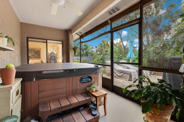 sunroom with ceiling fan and a jacuzzi