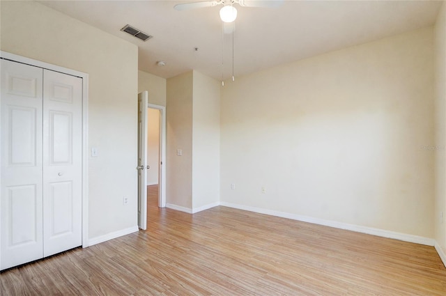 unfurnished bedroom with ceiling fan, a closet, and light hardwood / wood-style flooring