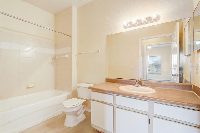 full bathroom with vanity, tile patterned flooring, toilet, and tiled shower / bath