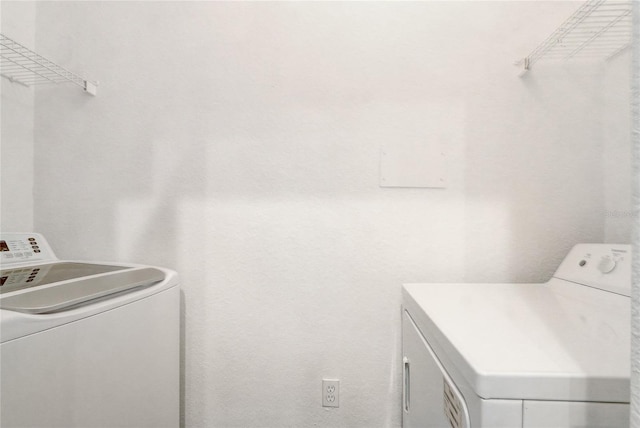 laundry room with washing machine and clothes dryer