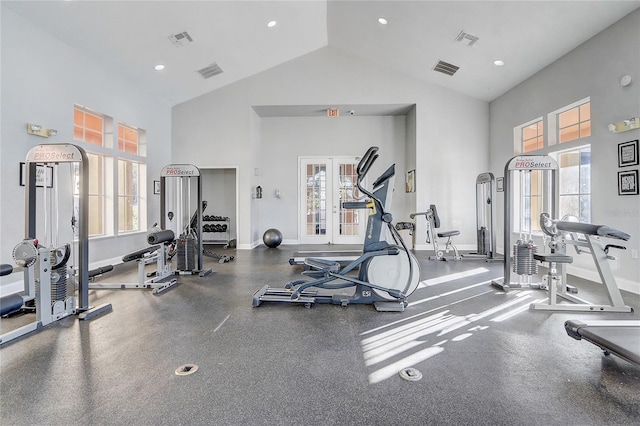 workout area with a wealth of natural light, high vaulted ceiling, and french doors