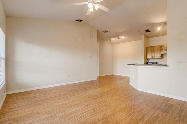 5961 Westgate Dr Unit 2034, Orlando, FL 32835 - unfurnished living room with vaulted ceiling, rail lighting, ceiling fan, and light wood-style flooring