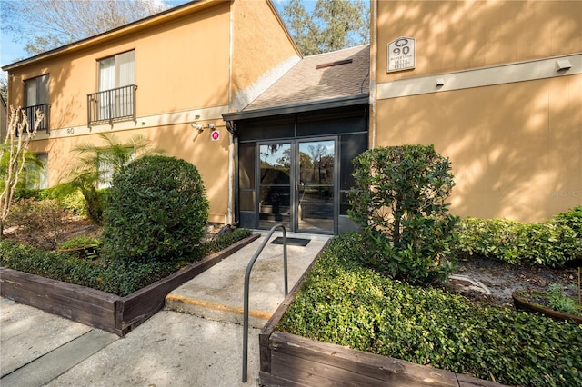 view of exterior entry featuring french doors