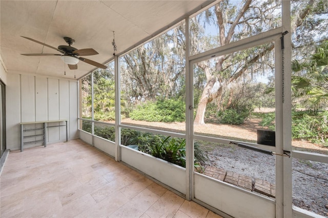 unfurnished sunroom with ceiling fan