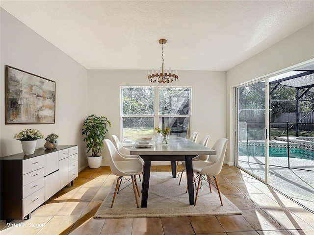 dining room featuring a notable chandelier, light tile patterned floors, and a textured ceiling