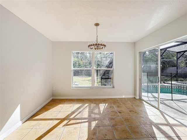 unfurnished dining area with a healthy amount of sunlight, tile patterned flooring, a textured ceiling, and a notable chandelier