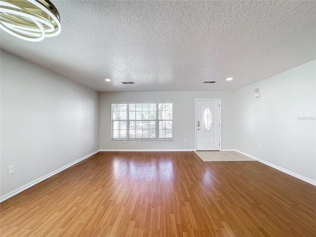 foyer featuring a textured ceiling and light wood-type flooring