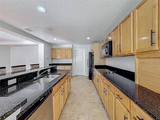 kitchen with dark stone countertops, sink, a textured ceiling, and black appliances